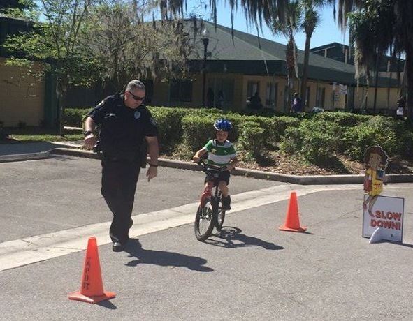 Police Officer with Child on Bike